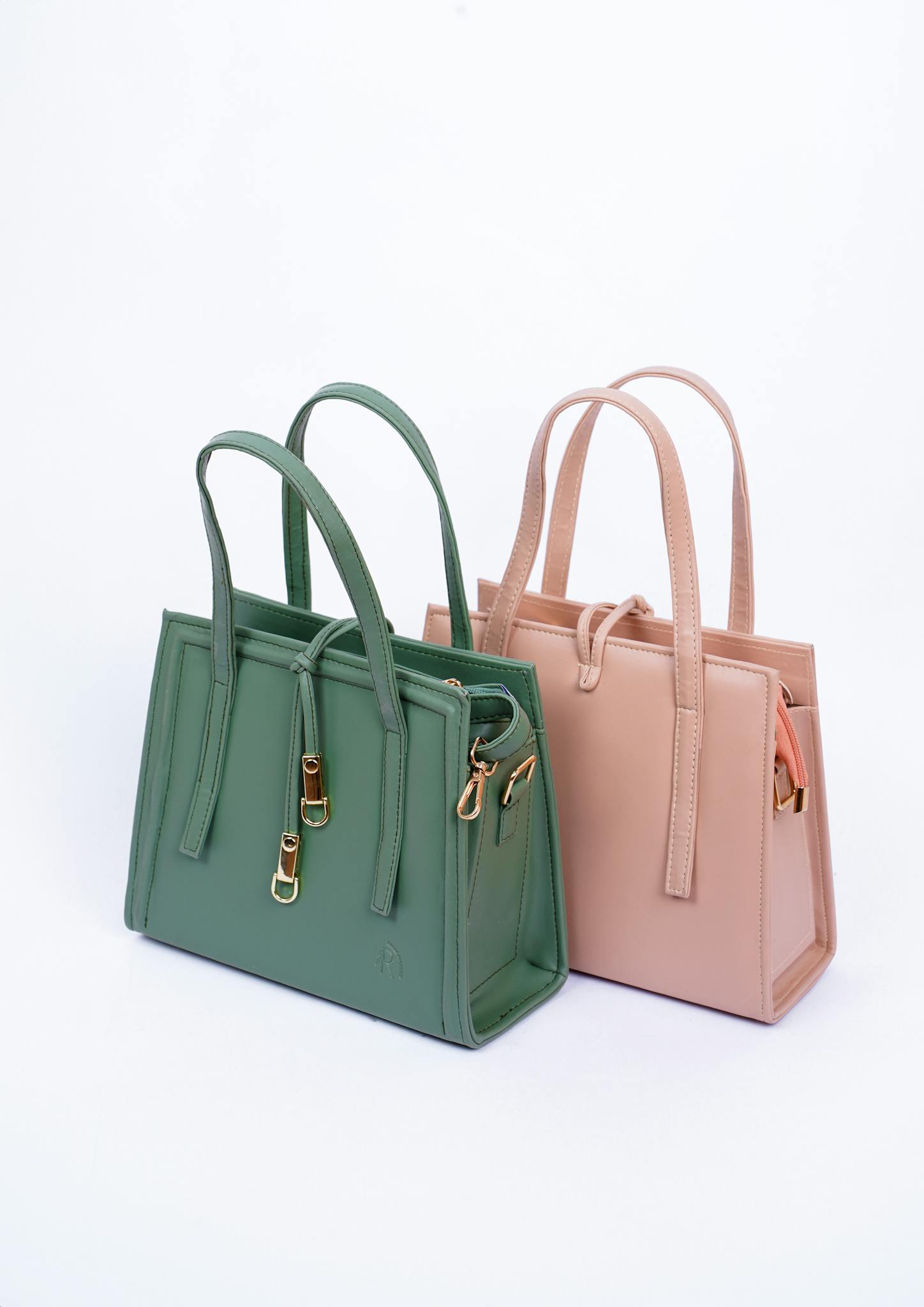 Modern fashion tote bags in green and pink leather, perfect for stylish accessories.